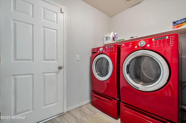 14570 S Sumac Dr, Sahuarita, AZ 85629 - washroom featuring washer and dryer, baseboards, and wood finished floors