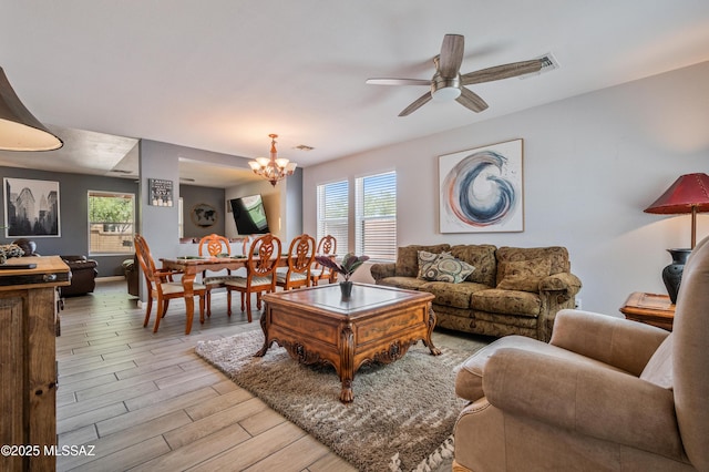 14570 S Sumac Dr, Sahuarita, AZ 85629 - living area featuring a chandelier, light wood finished floors, and a ceiling fan