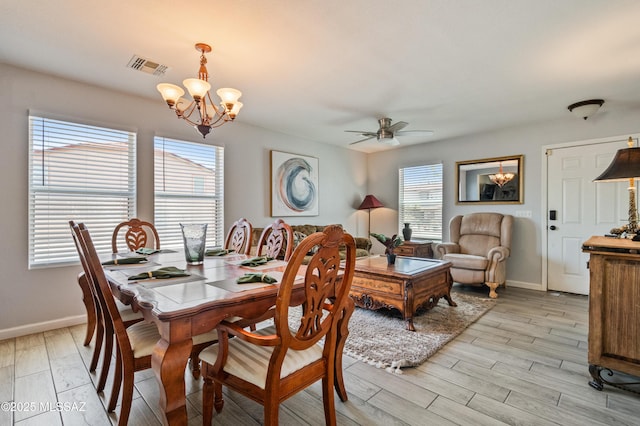 14570 S Sumac Dr, Sahuarita, AZ 85629 - dining space with ceiling fan, light wood-style flooring, a chandelier, and baseboards