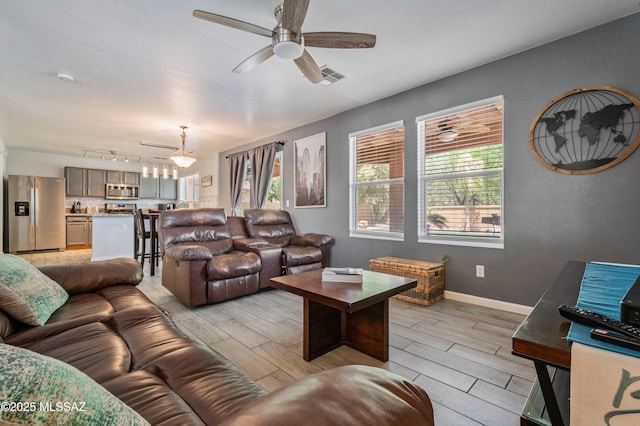 14570 S Sumac Dr, Sahuarita, AZ 85629 - living area with wood tiled floors, ceiling fan, track lighting, and baseboards