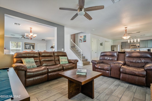 14570 S Sumac Dr, Sahuarita, AZ 85629 - living room featuring ceiling fan, wood tiled floors, a chandelier, and stairway