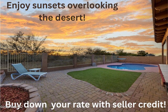 14024 E Fairway Bluff Ct, Vail, AZ 85641 - pool at dusk featuring a patio area