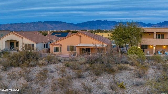 14024 E Fairway Bluff Ct, Vail, AZ 85641 - back of property featuring a mountain view, a fenced backyard, stucco siding, and a tiled roof