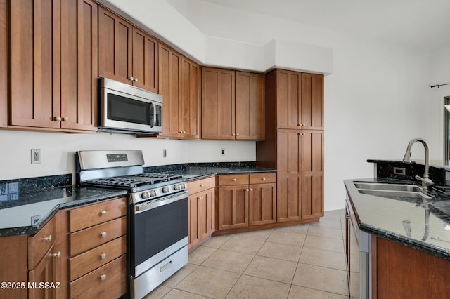 14024 E Fairway Bluff Ct, Vail, AZ 85641 - kitchen with stainless steel appliances, a sink, light tile patterned floors, and dark stone counters