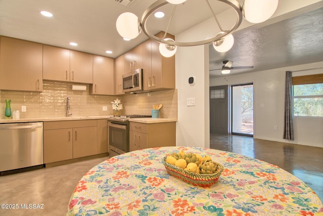 3341 E 23rd St, Tucson, AZ 85713 - kitchen featuring appliances with stainless steel finishes, light countertops, a sink, tasteful backsplash, and finished concrete floors