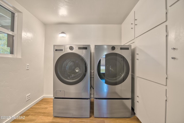 3341 E 23rd St, Tucson, AZ 85713 - laundry room featuring washer and dryer, light wood finished floors, and baseboards