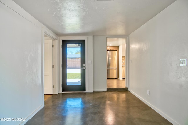 3341 E 23rd St, Tucson, AZ 85713 - foyer entrance with baseboards and concrete floors