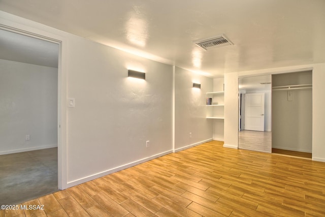 3341 E 23rd St, Tucson, AZ 85713 - unfurnished bedroom featuring wood finished floors and baseboards