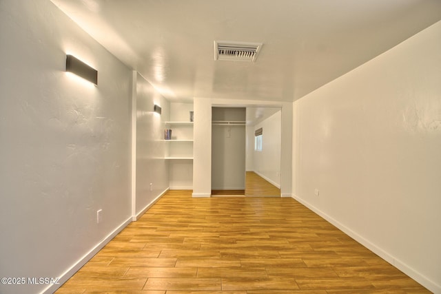 3341 E 23rd St, Tucson, AZ 85713 - unfurnished bedroom featuring wood finished floors, baseboards, and a closet
