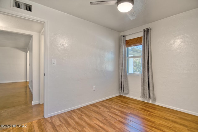3341 E 23rd St, Tucson, AZ 85713 - spare room with ceiling fan, light wood finished floors, baseboards, and a textured wall
