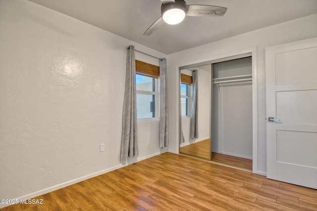 3341 E 23rd St, Tucson, AZ 85713 - unfurnished bedroom featuring light wood-style flooring, baseboards, ceiling fan, a closet, and a textured wall
