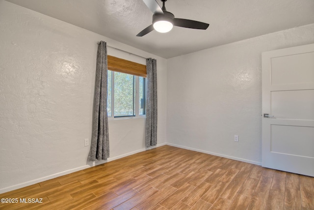 3341 E 23rd St, Tucson, AZ 85713 - spare room featuring a textured wall, light wood-style flooring, a ceiling fan, and baseboards