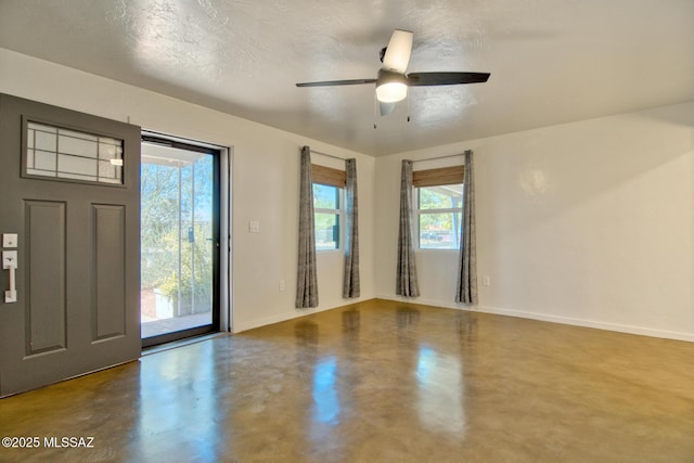 3341 E 23rd St, Tucson, AZ 85713 - spare room with finished concrete floors, baseboards, and ceiling fan