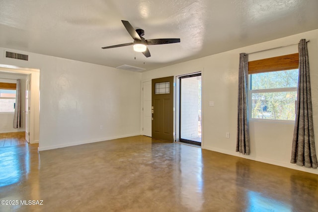 3341 E 23rd St, Tucson, AZ 85713 - unfurnished room featuring concrete floors, baseboards, a ceiling fan, and a textured ceiling