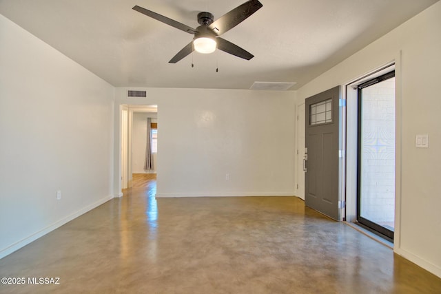 3341 E 23rd St, Tucson, AZ 85713 - spare room featuring concrete floors, baseboards, and a ceiling fan
