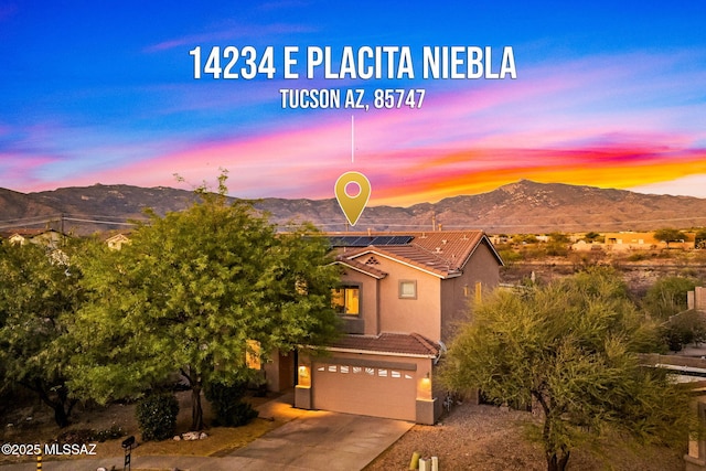14234 E Placita Niebla, Tucson, AZ 85747 - view of front of home featuring a tiled roof, a mountain view, an attached garage, and solar panels