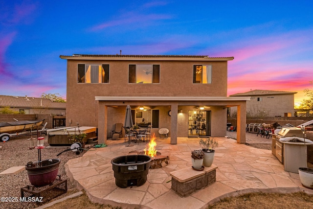 14234 E Placita Niebla, Tucson, AZ 85747 - rear view of house with an outdoor fire pit, stucco siding, a patio, and fence