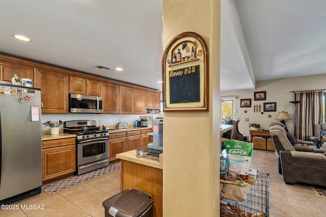 14234 E Placita Niebla, Tucson, AZ 85747 - kitchen with appliances with stainless steel finishes, light tile patterned floors, light countertops, open floor plan, and recessed lighting