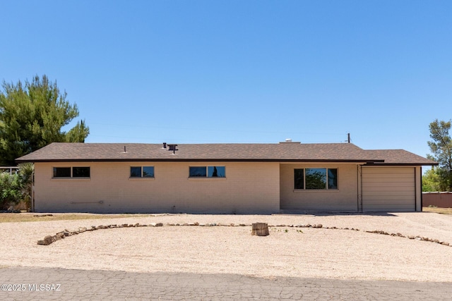 1540 N Calle Valencia, Oracle, AZ 85623 - back of house featuring a garage and brick siding