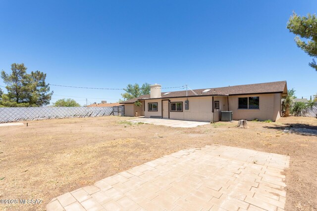 1540 N Calle Valencia, Oracle, AZ 85623 - back of property with central AC, a patio, fence, and a chimney