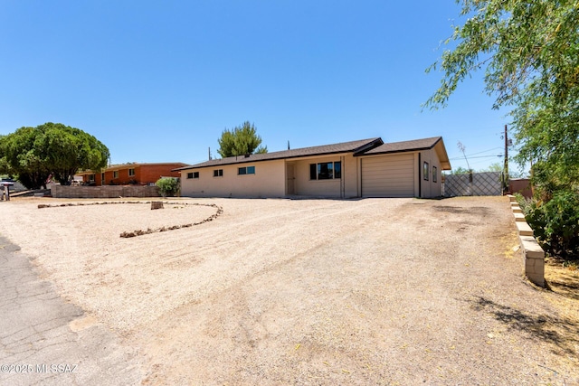 1540 N Calle Valencia, Oracle, AZ 85623 - ranch-style home with a garage, fence, and dirt driveway