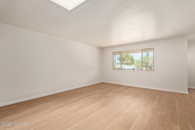 1540 N Calle Valencia, Oracle, AZ 85623 - empty room featuring light wood finished floors and baseboards