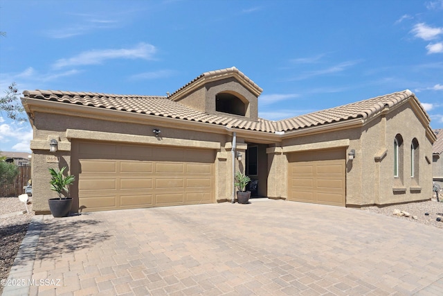9693 N Melandra Way, Marana, AZ 85653 - view of front of home with a garage, decorative driveway, a tiled roof, and stucco siding