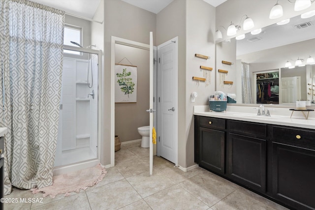 9693 N Melandra Way, Marana, AZ 85653 - bathroom featuring vanity, tile patterned flooring, toilet, a walk in closet, and baseboards