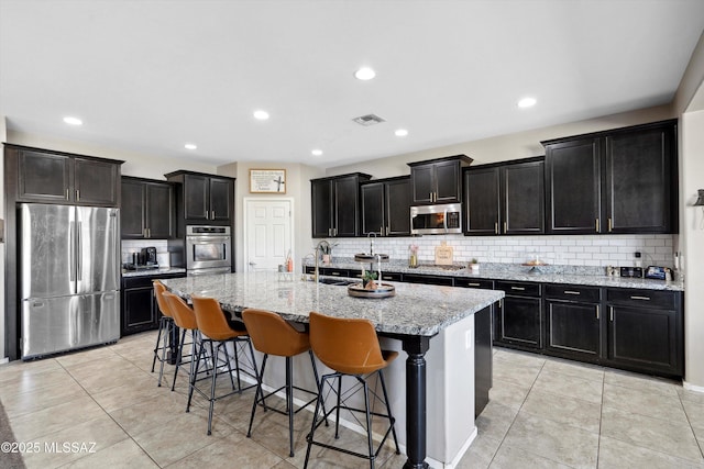 9693 N Melandra Way, Marana, AZ 85653 - kitchen featuring appliances with stainless steel finishes, decorative backsplash, dark cabinetry, and recessed lighting