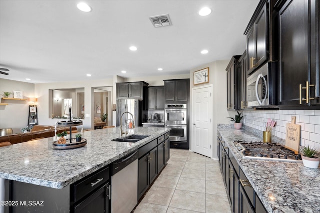 9693 N Melandra Way, Marana, AZ 85653 - kitchen with a sink, stainless steel appliances, open floor plan, tasteful backsplash, and recessed lighting