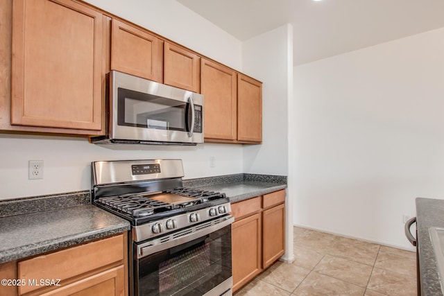 6837 W Leeward Cove Way, Tucson, AZ 85757 - kitchen with stainless steel appliances, dark countertops, and light tile patterned flooring