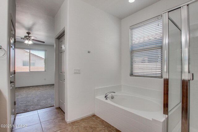6837 W Leeward Cove Way, Tucson, AZ 85757 - bathroom with ceiling fan, a bath, a stall shower, and baseboards