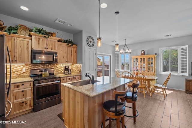 2108 W Moon Milk St, Benson, AZ 85602 - kitchen with gas range, a sink, tasteful backsplash, refrigerator, and light stone counters