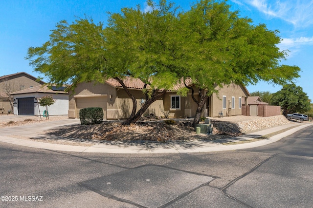 2108 W Moon Milk St, Benson, AZ 85602 - view of front of property featuring stucco siding, a garage, concrete driveway, roof mounted solar panels, and a tile roof