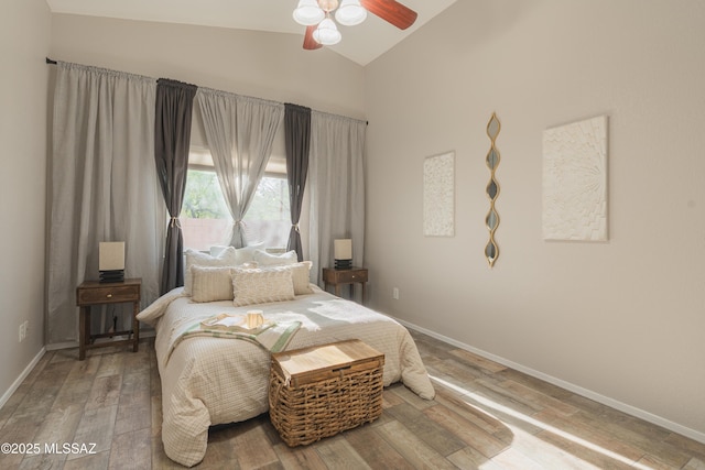 9536 N Scarlet Tanager Ln, Tucson, AZ 85742 - bedroom featuring baseboards, high vaulted ceiling, wood finished floors, and ceiling fan