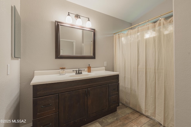 9536 N Scarlet Tanager Ln, Tucson, AZ 85742 - full bathroom featuring vanity and vaulted ceiling