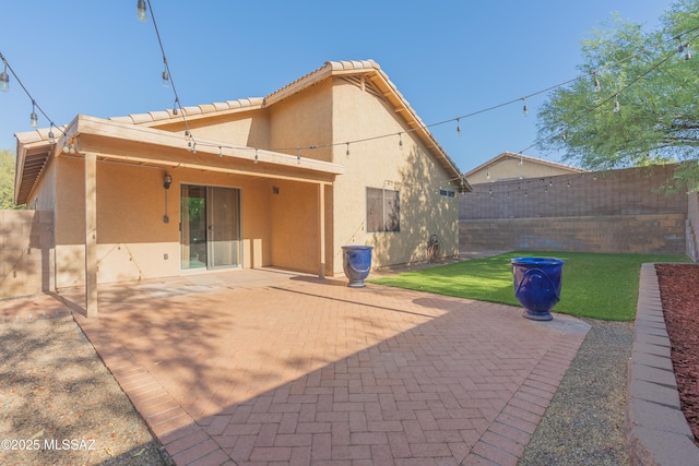 9536 N Scarlet Tanager Ln, Tucson, AZ 85742 - back of property with stucco siding and a patio
