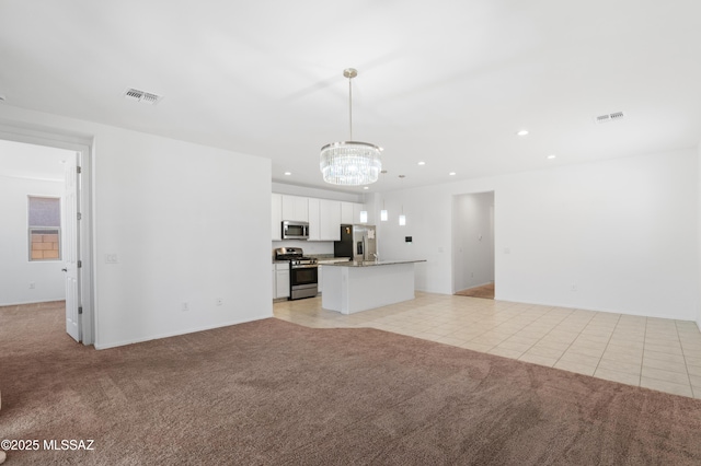 unfurnished living room featuring light carpet, a chandelier, light tile patterned floors, recessed lighting, and baseboards