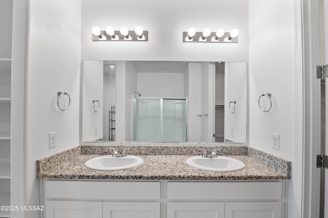 full bathroom with a shower stall, double vanity, and a spacious closet