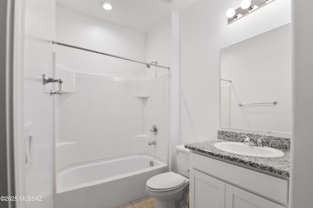 bathroom featuring toilet, vanity, washtub / shower combination, and tile patterned floors