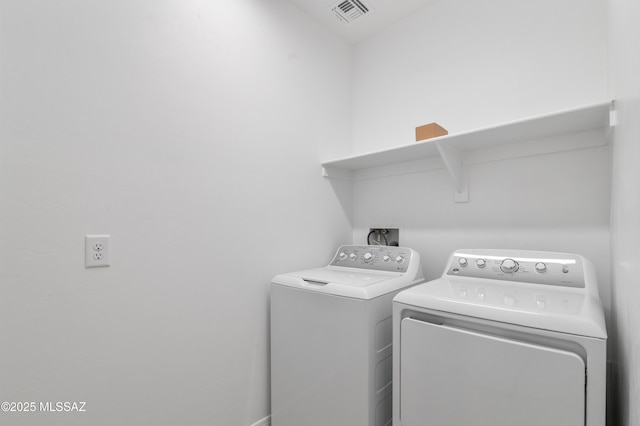 washroom with independent washer and dryer