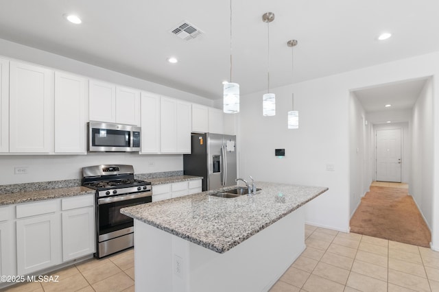 kitchen with stainless steel appliances, a sink, light tile patterned floors, white cabinetry, and recessed lighting