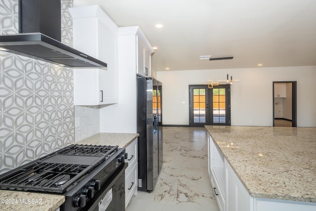 1920 W Pueblo Vista Blvd, Tucson, AZ 85713 - kitchen featuring wall chimney range hood, black gas range oven, french doors, backsplash, and white cabinetry