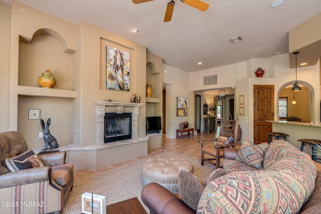 124 Circulo Vespucci, Tubac, AZ 85646 - tiled living room featuring built in features, a ceiling fan, a high end fireplace, and recessed lighting