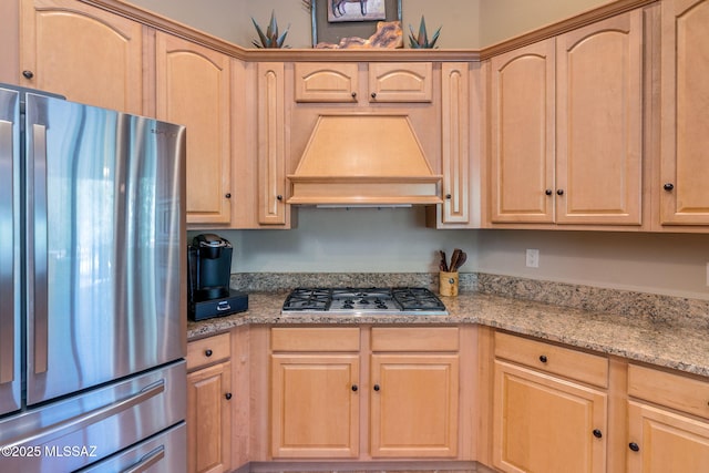 124 Circulo Vespucci, Tubac, AZ 85646 - kitchen with appliances with stainless steel finishes, light brown cabinetry, custom range hood, and light stone counters