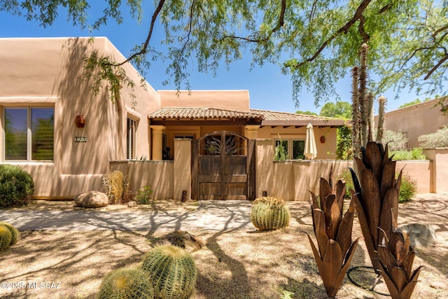 124 Circulo Vespucci, Tubac, AZ 85646 - rear view of property featuring fence, a tile roof, and stucco siding