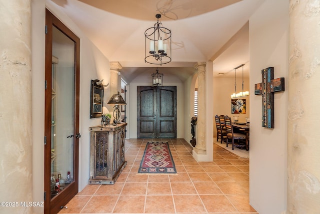 124 Circulo Vespucci, Tubac, AZ 85646 - entryway with light tile patterned floors, a chandelier, and decorative columns