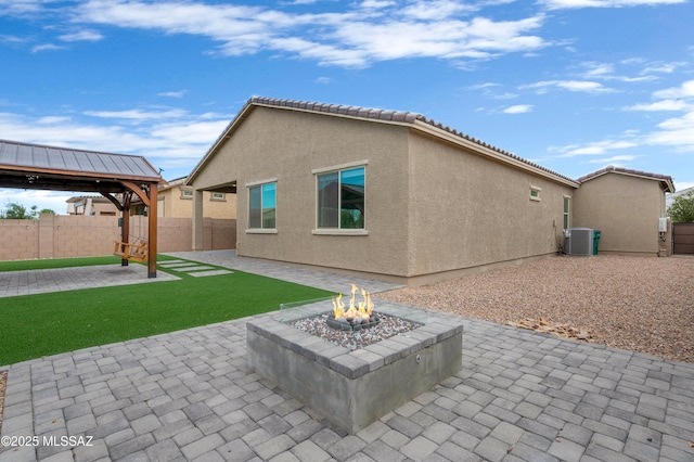 12513 Denton Way, Marana, AZ 85653 - rear view of property with a patio area, central AC, a gazebo, a fire pit, and stucco siding