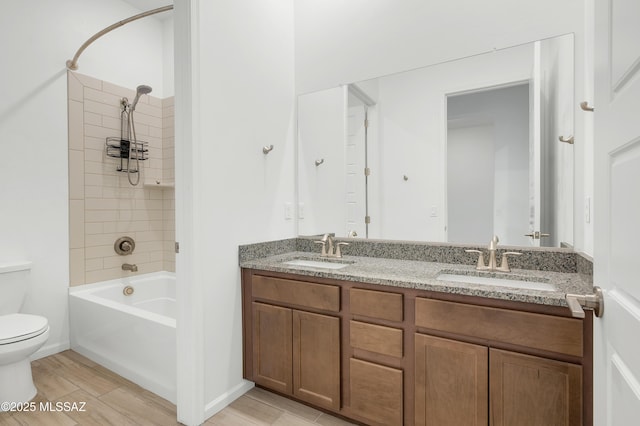 12513 Denton Way, Marana, AZ 85653 - bathroom featuring toilet, double vanity, tub / shower combination, and wood finished floors