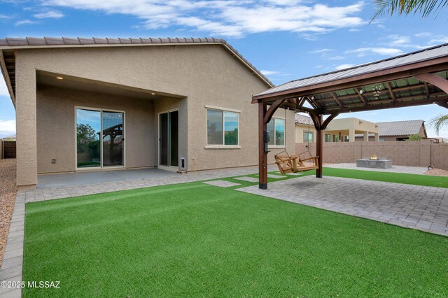 12513 Denton Way, Marana, AZ 85653 - rear view of house featuring a gazebo, stucco siding, a patio, and a fire pit
